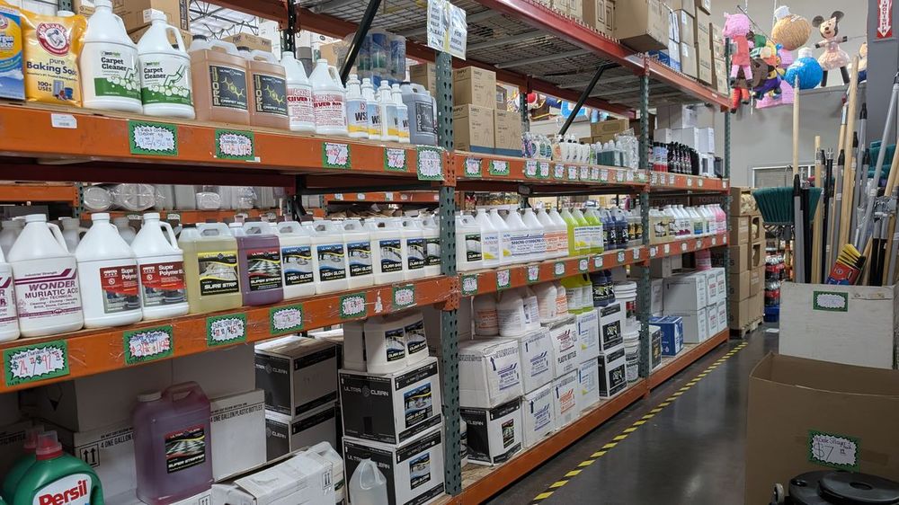 Shelves of bulk cleaning chemicals and janitorial supplies