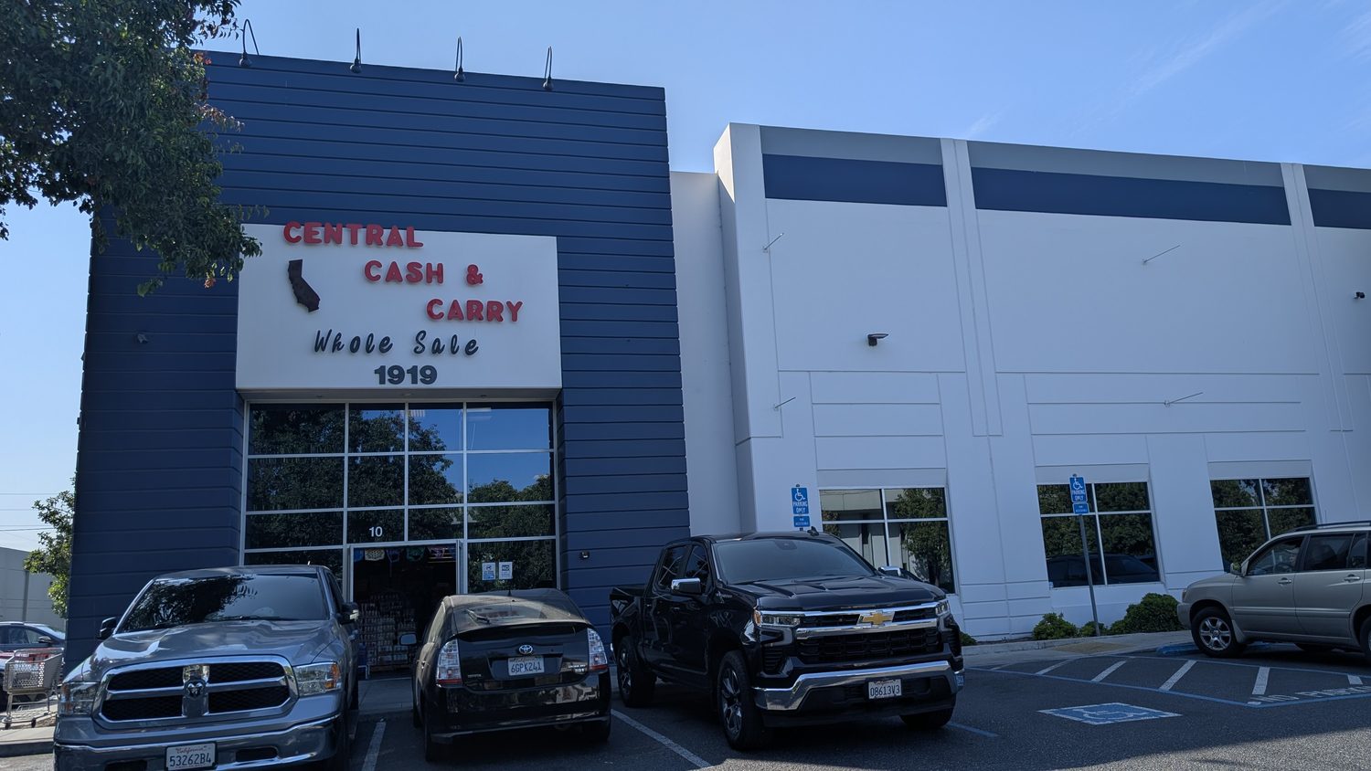 Front view of the Central Cash & Carry building and parking in San Jose